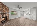 Spacious living room features a stone fireplace and seamless flow into the kitchen area at 1112 Observation Dr # 201, Las Vegas, NV 89128