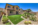 Low maintenance backyard featuring artificial turf, desert landscaping, and a private block wall at 12546 Mosticone Way, Las Vegas, NV 89141
