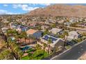 Beautiful aerial shot showcases the property, pool and stunning mountain views at 1407 Fields St, Las Vegas, NV 89142