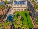Expansive backyard features a sparkling pool, manicured lawn, and covered patio at 1407 Fields St, Las Vegas, NV 89142