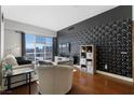 Living room showcasing modern black accent wall, city views and hardwood floors at 150 Las Vegas Blvd # 1608, Las Vegas, NV 89101