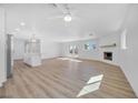 Spacious living area with fireplace, ceiling fan, and french doors to the backyard at 1616 Yellow Rose St, Las Vegas, NV 89108