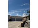 Two-car garage with a paved driveway and desert landscaping at 1826 Dunes Ct, Laughlin, NV 89029