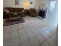 Cozy living room featuring tile flooring, a fireplace, and ample seating at 1826 Dunes Ct, Laughlin, NV 89029