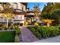 Inviting front entrance with decorative metal door and lush landscaping at 2 Yorkridge Ct, Henderson, NV 89052