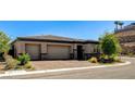 Single-story home featuring a three-car garage and landscaped front yard on a quiet street at 21 Reverie Heights Ave, Henderson, NV 89011
