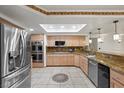 Modern kitchen featuring stainless steel appliances, granite countertops, and custom cabinetry at 2112 Preakness Pass, Las Vegas, NV 89117