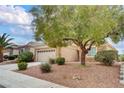 Single-story home boasting a two-car garage, desert landscaping and attractive curb appeal at 2343 Galilean Moon St, Henderson, NV 89044