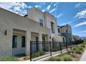 Beautiful home exterior featuring an attractive architectural style, wrought iron fence, and desert landscaping at 2726 Marchetti Pl, Henderson, NV 89044