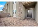 Stylish townhome entrance with a brick patio and stone facade elements at 334 Laurel Peak Dr, Henderson, NV 89015