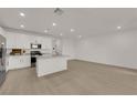 Bright open-concept space with luxury vinyl plank flooring and a view to the kitchen at 334 Laurel Peak Dr, Henderson, NV 89015