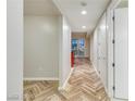 Hallway featuring herringbone floors, recessed lighting, and modern white doors at 4575 Dean Martin Dr # 2701, Las Vegas, NV 89103