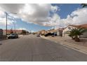 Neighborhood street view showing single-story homes with desert landscaping and a classic terra cotta roofs at 517 Scenic Terra Dr, Henderson, NV 89015