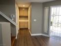 Bright entryway boasts wood laminate flooring, storage, and security screen door at 5201 S Torrey Pines Dr # 1253, Las Vegas, NV 89118