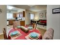 Dining room with a set table, open to the kitchen and living area at 5250 S Rainbow Blvd # 1084, Las Vegas, NV 89118