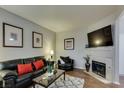Cozy living room features a leather sofa with accent pillows, fireplace, and modern decor at 5250 S Rainbow Blvd # 1084, Las Vegas, NV 89118