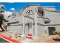 Exterior view of a multi-story condo with a white facade and a private entrance at 5516 Orchard Ln # 0, Las Vegas, NV 89110