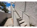 Outdoor staircase leading to the upper-level condos, surrounded by greenery at 5516 Orchard Ln # 0, Las Vegas, NV 89110