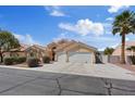 Charming single-story home with three-car garage, desert landscaping, and a tile roof at 5812 Spinnaker Reach Ave, Las Vegas, NV 89130