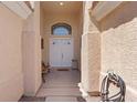 Inviting front entrance with double doors, decorative transom window, and neutral stucco exterior at 5812 Spinnaker Reach Ave, Las Vegas, NV 89130
