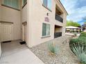 Inviting condo exterior with desert landscaping and an outdoor picnic area nearby at 6635 Flaminian Ln # 104, North Las Vegas, NV 89084