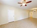 Open-concept living room showcasing neutral paint, tile flooring, and abundant natural light at 6635 Flaminian Ln # 104, North Las Vegas, NV 89084