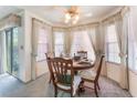Bright dining area features large windows, and a classic wooden dining set at 7617 Sea Cliff Way, Las Vegas, NV 89128