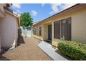 Side exterior featuring a well-maintained walkway and gate access to the backyard at 7755 Pacific Rim Ct, Las Vegas, NV 89139