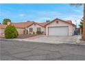 Charming single-story home featuring a well-maintained lawn and a two-car garage at 8024 Hackberry Dr, Las Vegas, NV 89123