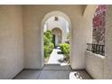 Exterior archway and walkway surrounded by mature landscaping at 820 Colina Alta Pl, Las Vegas, NV 89138