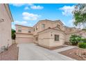 Spacious two-story house with a two car garage and xeriscape front yard at 8873 Happy Stream Ave, Las Vegas, NV 89143