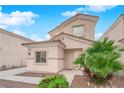 Inviting two-story home with a desert landscape, stucco exterior, and tile roofing at 8873 Happy Stream Ave, Las Vegas, NV 89143