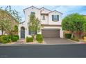 Charming two-story home with a brick driveway, landscaped yard, and a two car garage at 9496 Wild Valley Ave, Las Vegas, NV 89148