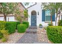 The front yard features stone pavers, desert landscaping, and a dark gray modern door at 9496 Wild Valley Ave, Las Vegas, NV 89148