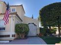 Charming single Gathering home featuring a well-manicured lawn, attractive landscaping, and an American flag at , Las Vegas, NV 89117