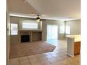 Inviting living room with a cozy fireplace, carpet and tile flooring, and bright natural light at 10195 Queensbury Ave, Las Vegas, NV 89135
