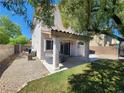 Backyard patio with a hot tub and ample space for outdoor entertaining at 10400 Beachwalk Pl, Las Vegas, NV 89144