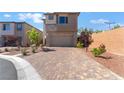 Lovely two-story home with desert landscaping, modern brick accents, and a brick paver driveway at 10793 Pastel Sunset Ct, Las Vegas, NV 89135