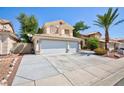 Charming two-story home featuring a three-car garage and low-maintenance landscaping in the front yard at 1246 E Gary Ave, Las Vegas, NV 89123
