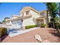Charming two-story home featuring a three-car garage and low-maintenance landscaping in the front yard at 1246 E Gary Ave, Las Vegas, NV 89123