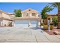 Two-story home featuring a three-car garage and low-maintenance landscaping in the front yard at 1246 E Gary Ave, Las Vegas, NV 89123