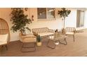 Cozy covered patio with comfortable wicker seating and a charming outdoor living space at 2043 Sombrero Dr, Las Vegas, NV 89169