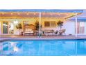 Relaxing outdoor covered patio with stylish furniture overlooking the refreshing in-ground pool at 2043 Sombrero Dr, Las Vegas, NV 89169