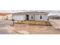 Charming single-story home with a two-car garage and desert landscaping at 2071 Idaho St, Pahrump, NV 89048
