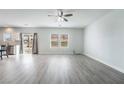 Spacious living room featuring wood floors, natural light and modern ceiling fan at 2071 Idaho St, Pahrump, NV 89048