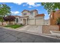 Two-story stucco house boasts a terracotta tile roof, lush lawn, and a convenient two-car garage at 2124 Rising Mist St, Las Vegas, NV 89134
