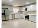 Bright kitchen featuring stainless steel appliances, white cabinetry, and ample counter space at 2135 Sombrero Dr, Las Vegas, NV 89169