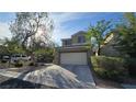 Beautiful two-story home with well-maintained landscaping, a driveway and a two-car garage at 2737 Rimbaud St, Henderson, NV 89044