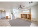 Open-concept living room with staircase, entertainment center, and tile flooring at 3448 Quiet Pueblo St, North Las Vegas, NV 89032