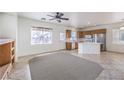 Bright living room showcasing a kitchen, tile floors, ceiling fan, and natural light at 3448 Quiet Pueblo St, North Las Vegas, NV 89032